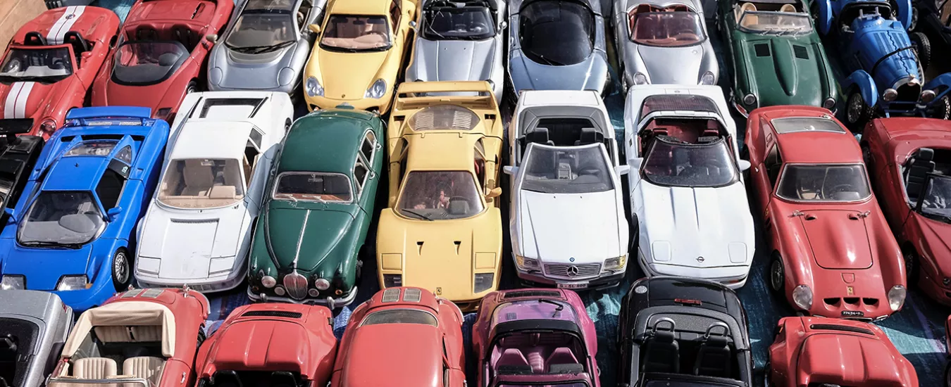 Cars in different colours parked in a parking lot