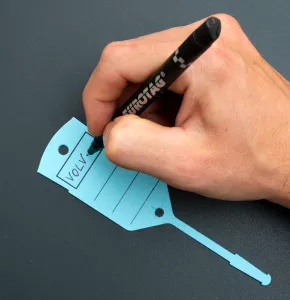 Jemand schreibt mit einem schwarzen Permanentmarker auf einen blauen Schlüsselanhänger mit Schlaufe